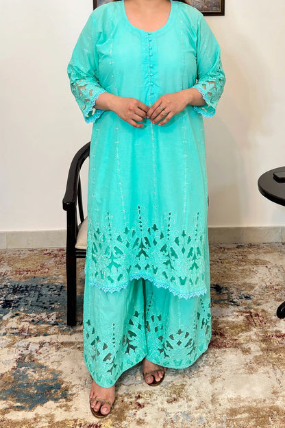 Close-up front view of the aqua-green cotton straight kurta showing the button placket and floral cutwork embroidery on the hem.