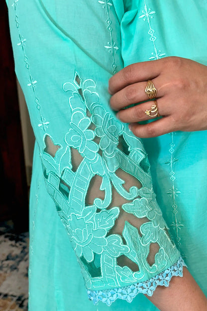Close-up of the sleeve of the aqua-green cotton straight kurta showing floral cutwork embroidery detail.