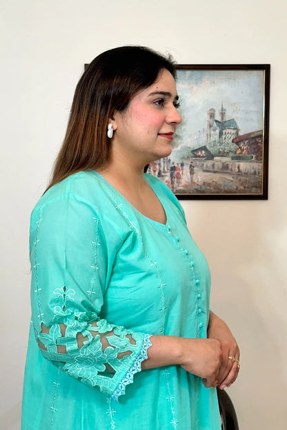 Close-up side view of the aqua-green cotton straight kurta showing the button placket and sleeve embroidery.