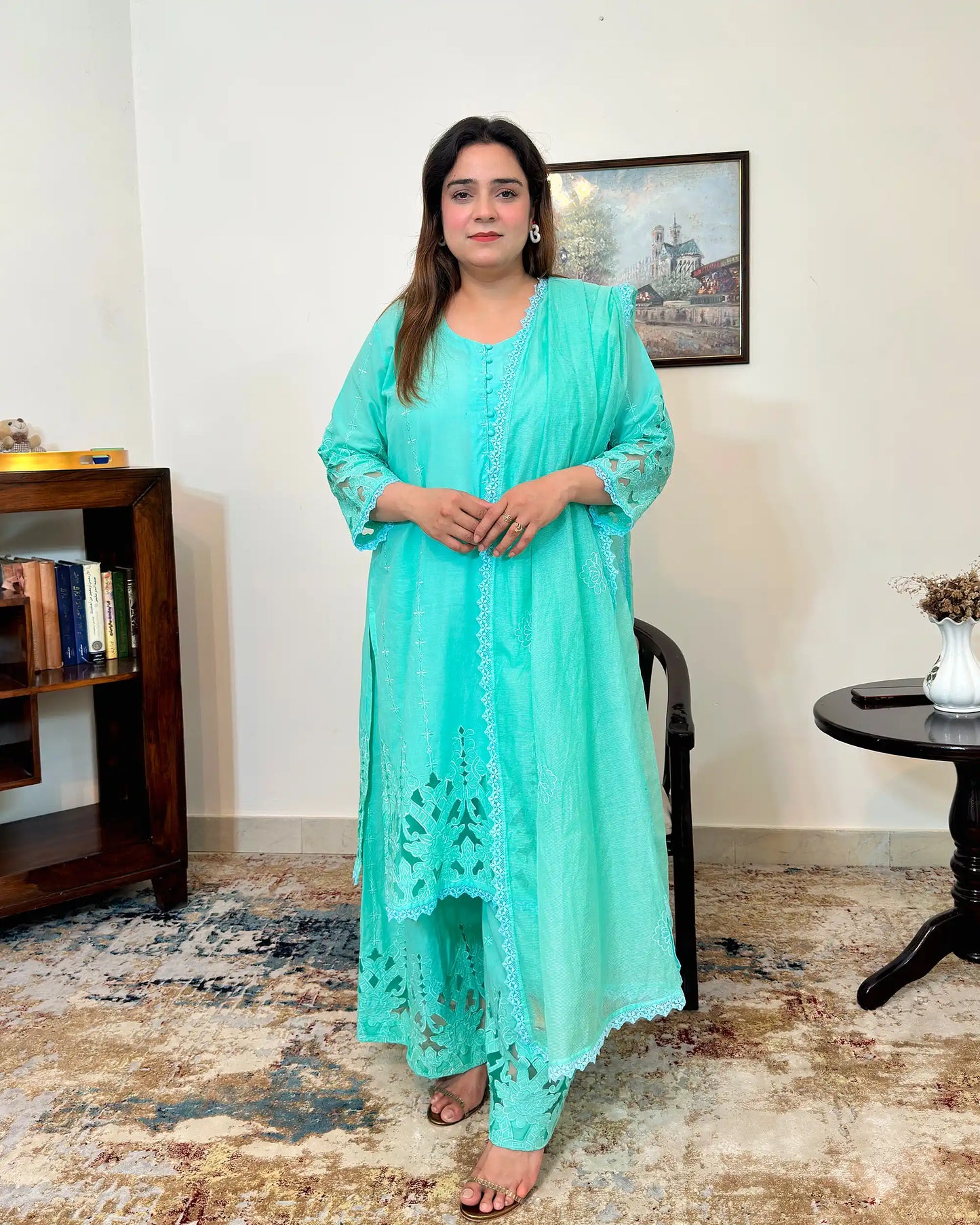 Front view of the aqua-green cotton straight kurta and net dupatta with floral cutwork embroidery, paired with matching aqua-green palazzo.