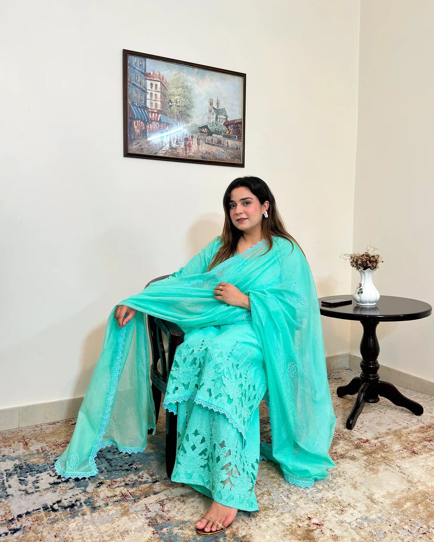 Front view of the aqua-green cotton straight kurta and net dupatta with floral cutwork embroidery, paired with matching aqua-green palazzo.