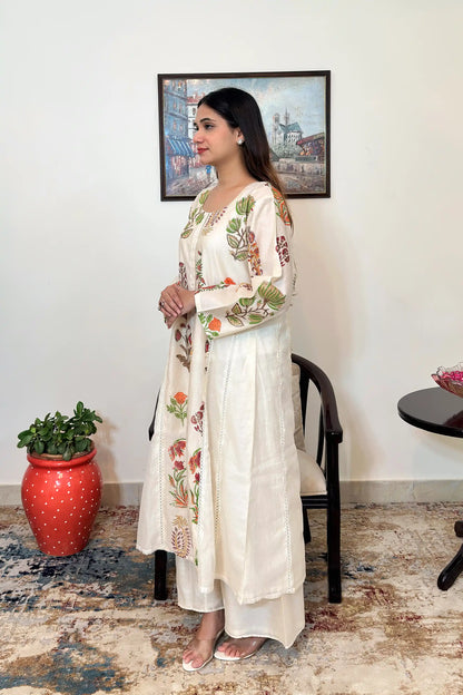 Side view of an off-white chanderi A-line kurta with multicolour floral mughal print, paired with off-white palazzo.
