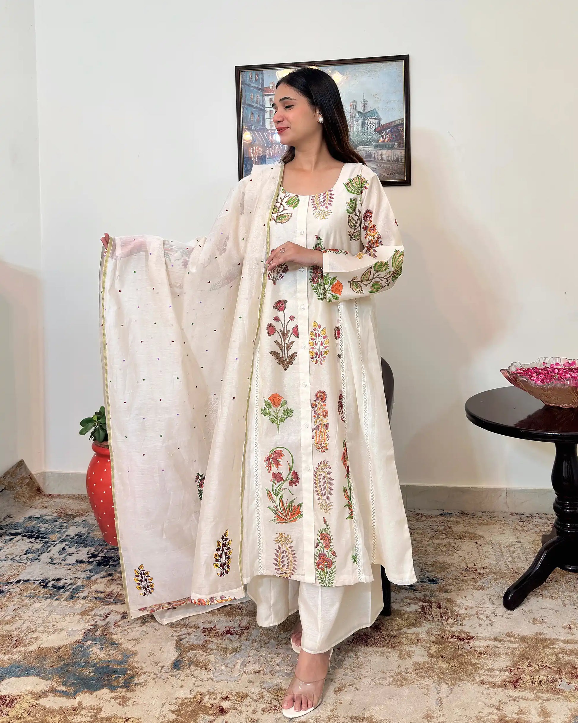 Front view of an off-white chanderi A-line kurta and dupatta with multicolour floral hand embroidery, paired with off-white palazzo.