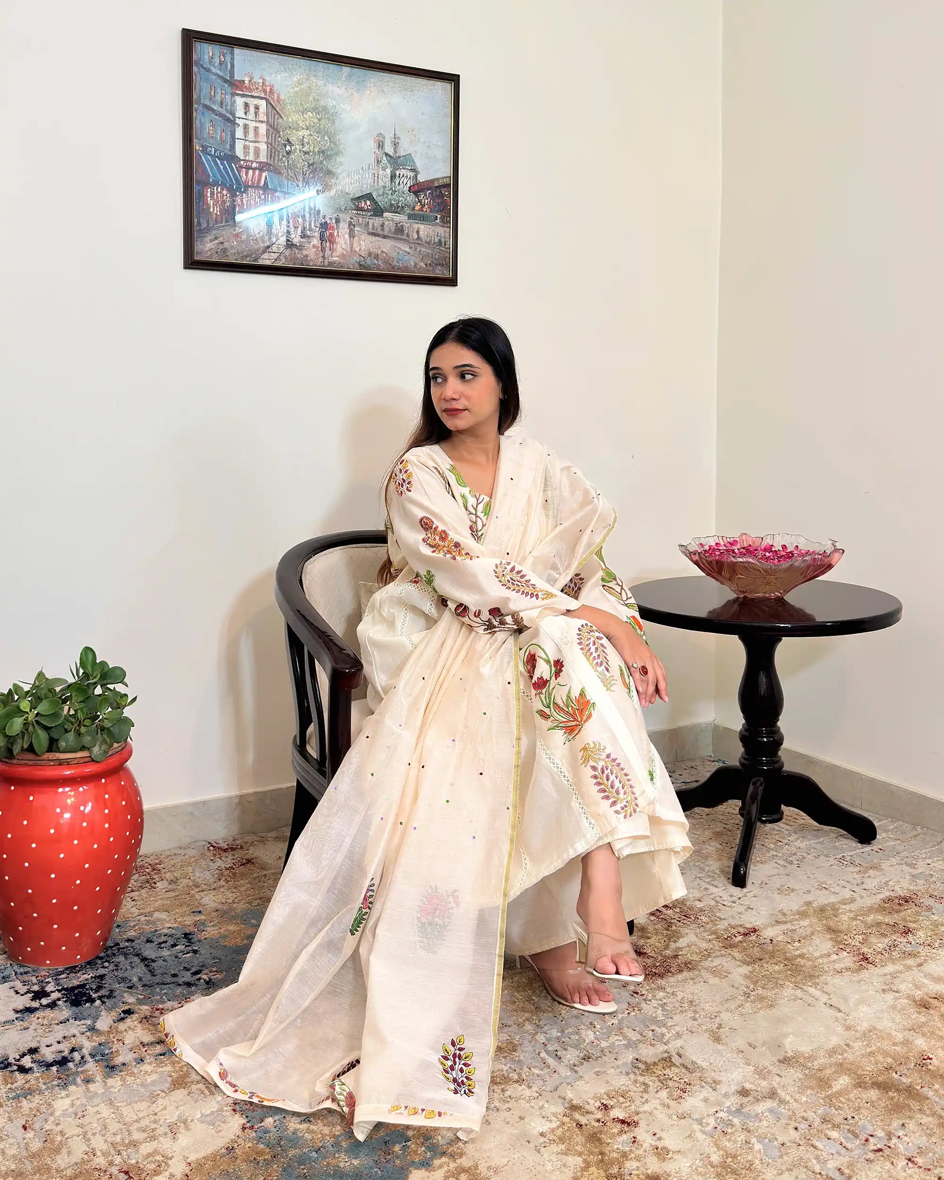 Front view of an off-white chanderi A-line kurta and dupatta with multicolour floral hand embroidery, paired with off-white palazzo.