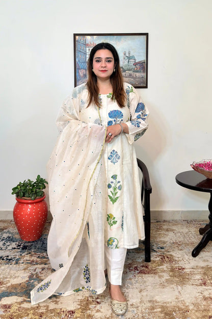 Front view of an off-white chanderi A-line kurta with blue-green floral mughal print, worn with a matching embroidered dupatta on and off-white trousers.