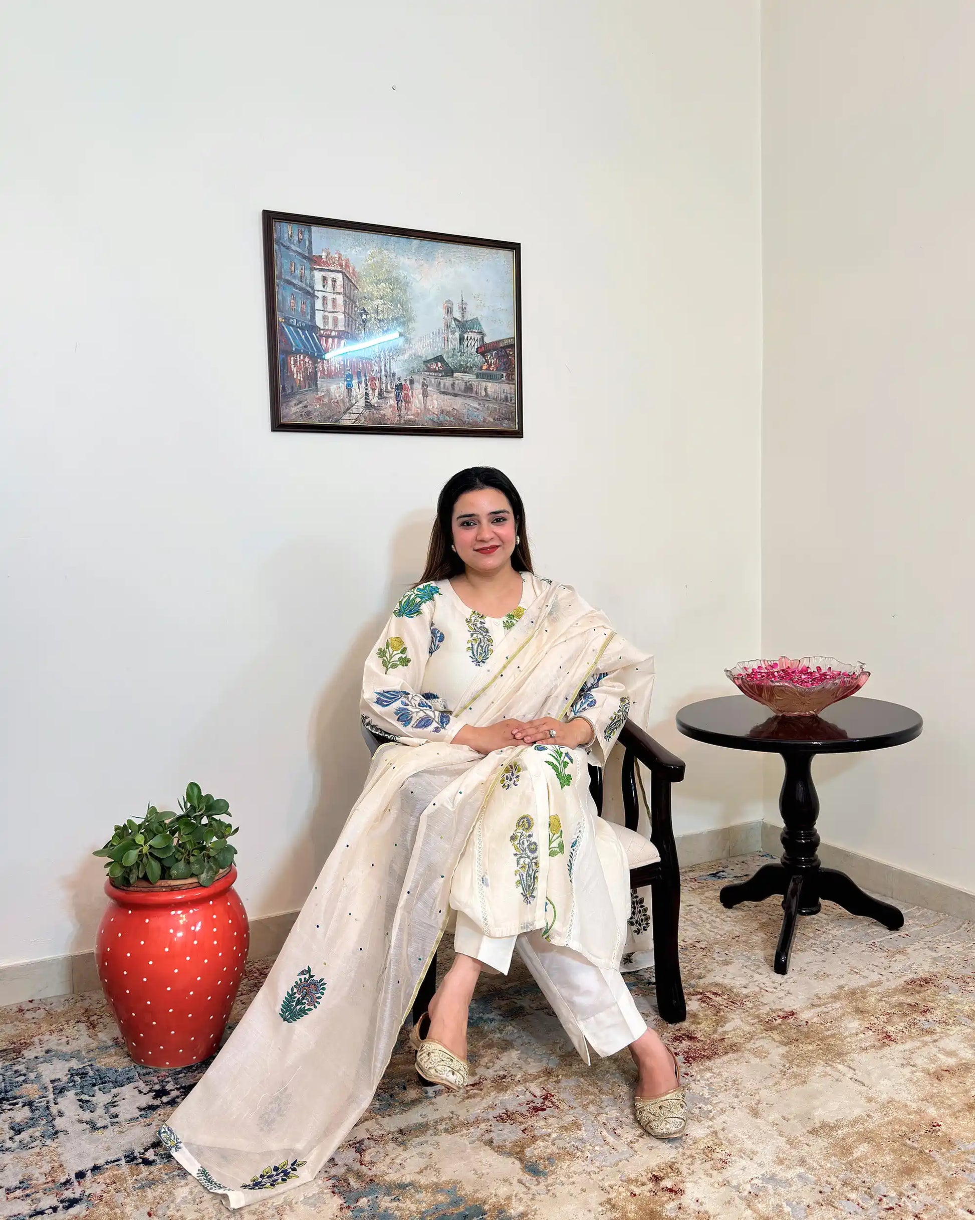 Front view of an off-white chanderi A-line kurta with floral print and dupatta with blue-green floral hand embroidery, worn with off-white trousers.