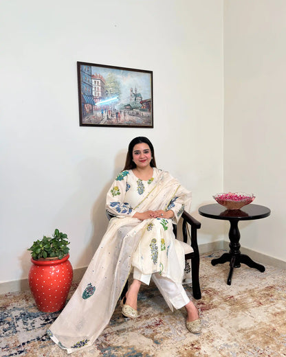 Front view of an off-white chanderi A-line kurta with floral print and dupatta with blue-green floral hand embroidery, worn with off-white trousers.