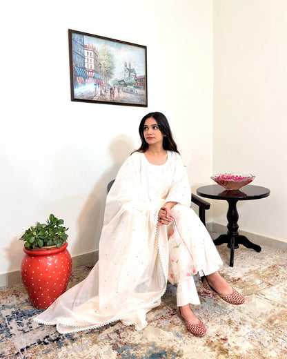 Front view of the off-white chanderi A-line kurta and dupatta with pink resham embroidery, worn with off-white trousers.