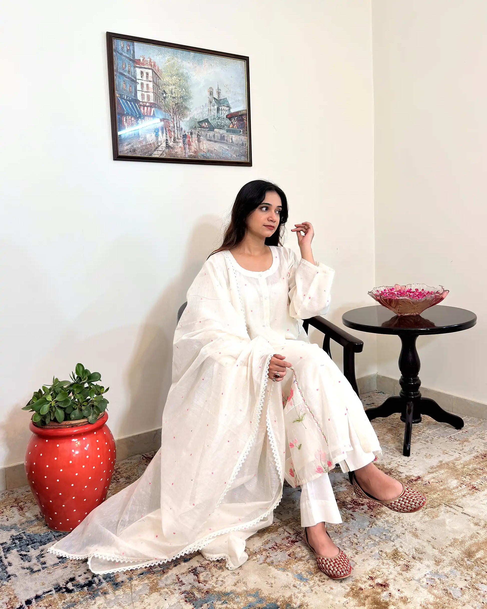 Front view of the off-white chanderi A-line kurta with pink resham embroidery, worn with off-white trousers.