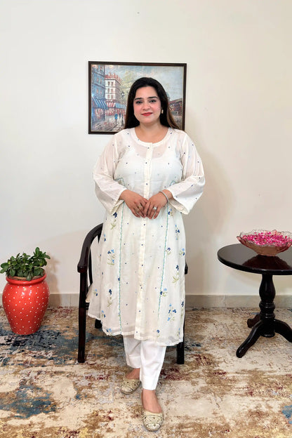 Front view of an off-white chanderi A-line kurta with dupatta off, showing blue floral resham embroidery along the front panels, paired with off-white trousers.