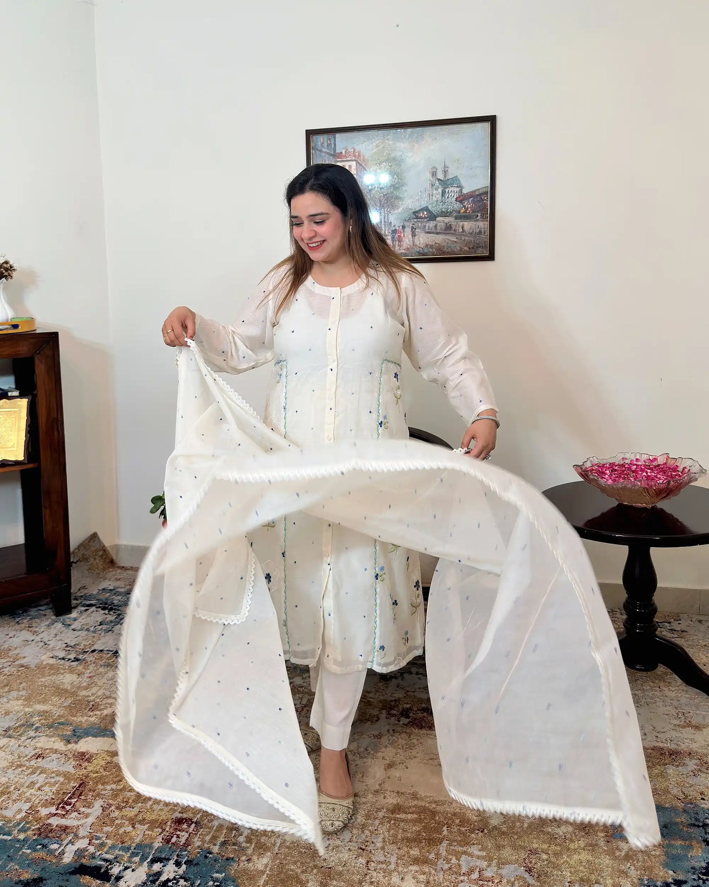 Front view of an off-white chanderi A-line kurta with dupatta on, showing blue floral resham embroidery along the front panels, paired with off-white trousers.
