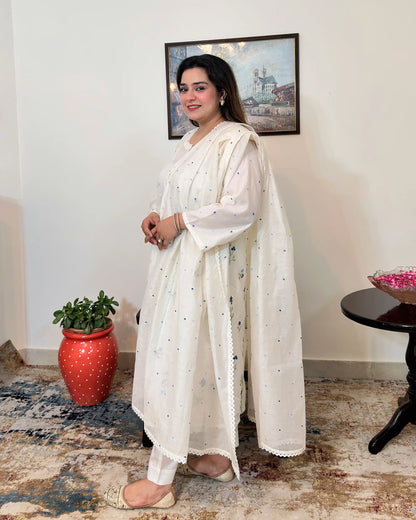 Side view of an off-white chanderi A-line kurta with dupatta on, showing blue floral resham embroidery on the kurta and scattered floral resham embroidery with a lace edge on the dupatta, paired with off-white trousers.
