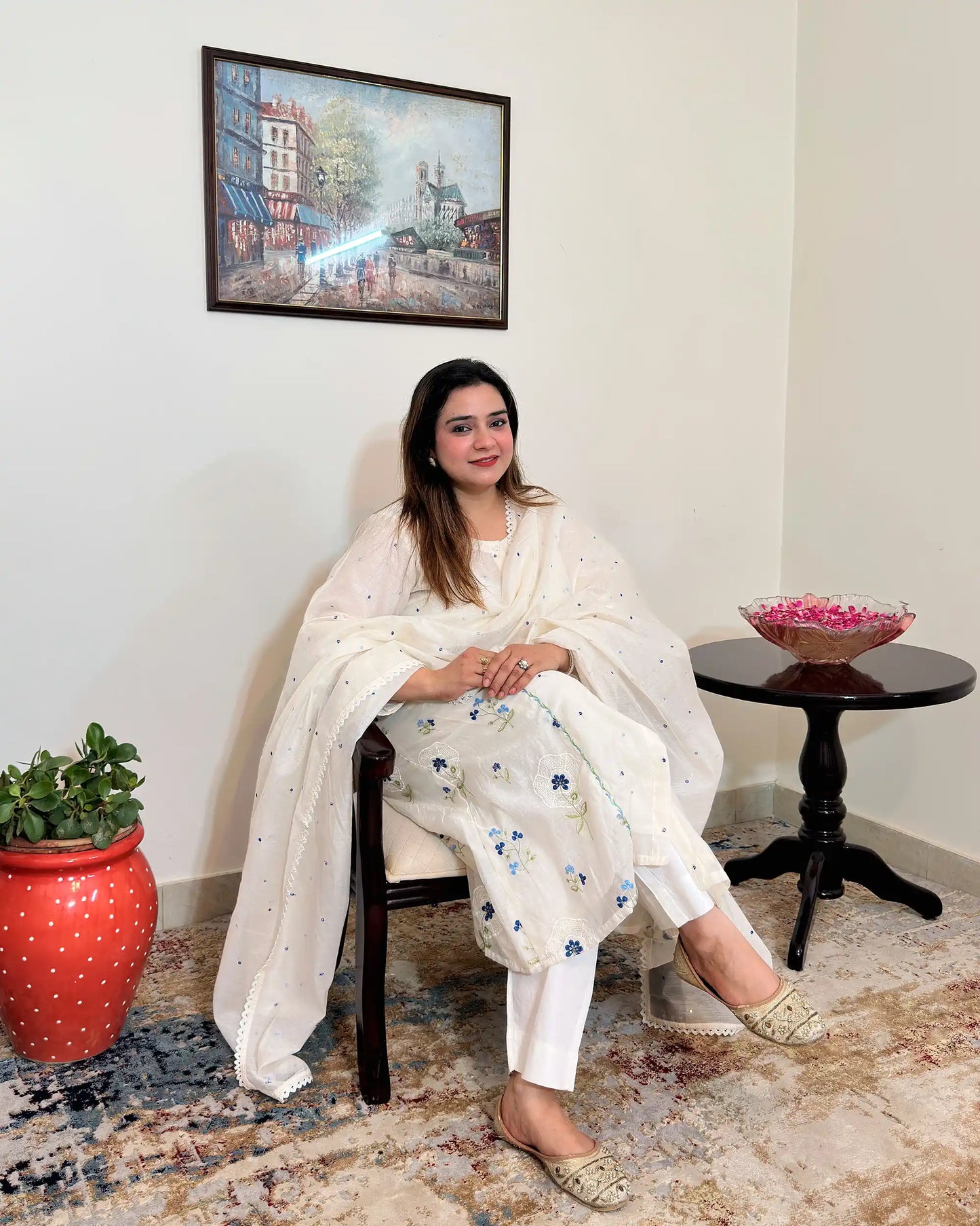 Front view of an off-white chanderi A-line kurta with dupatta on, showing blue floral resham embroidery on the kurta and scattered floral resham embroidery with a lace edge on the dupatta, paired with off-white trousers.