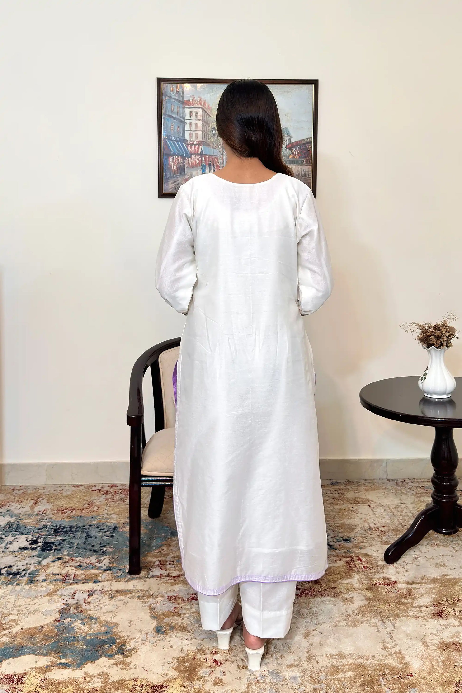 Back view of the off-white chanderi straight kurta, paired with off-white trousers.
