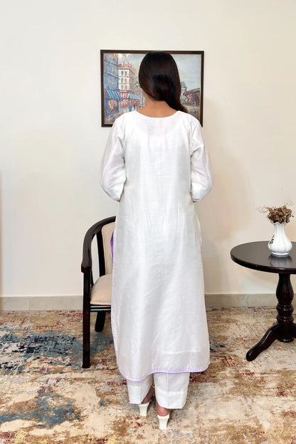 Back view of the off-white chanderi straight kurta, paired with off-white trousers.