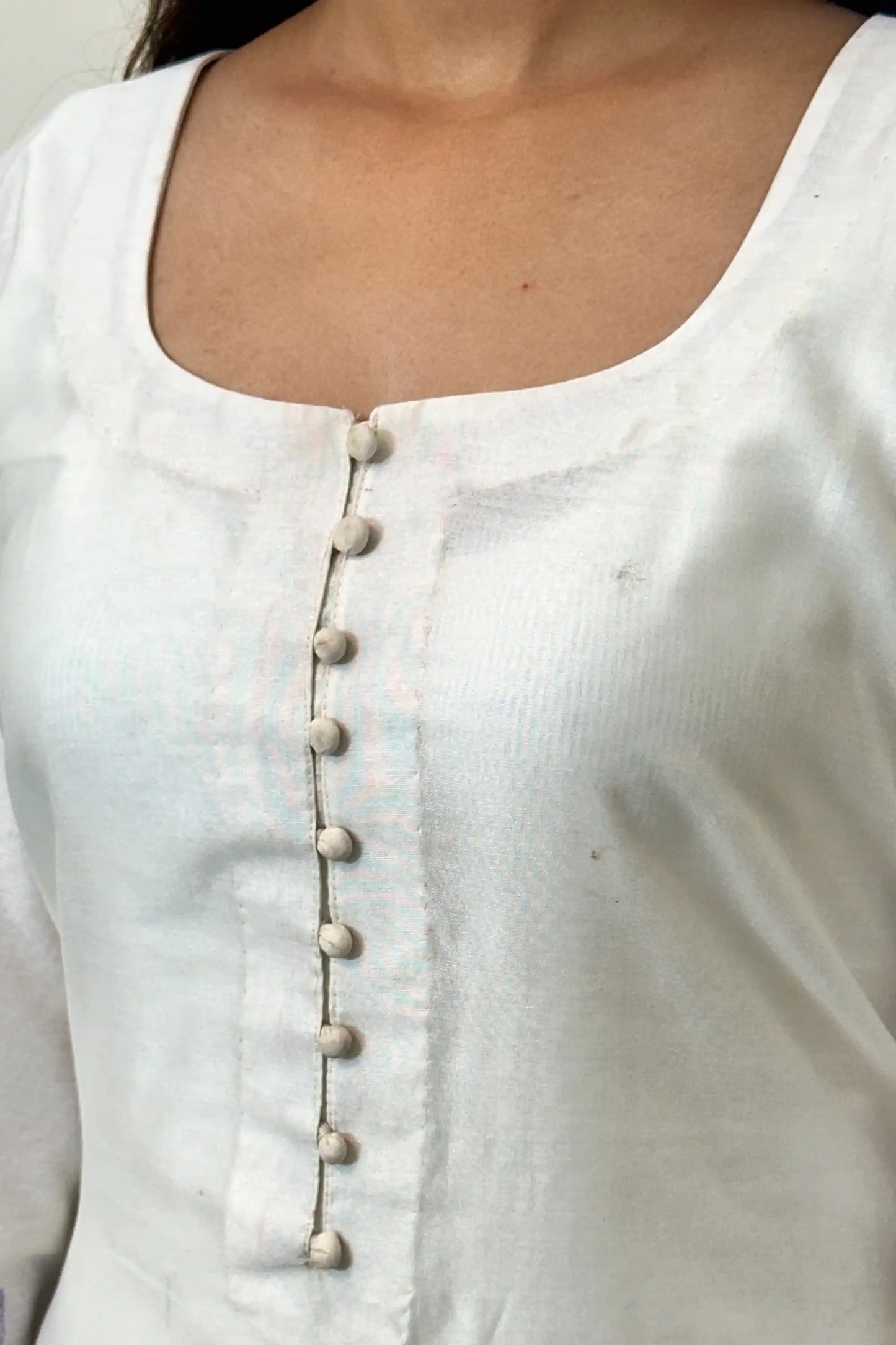 Close-up of the button placket on the off-white chanderi straight kurta.