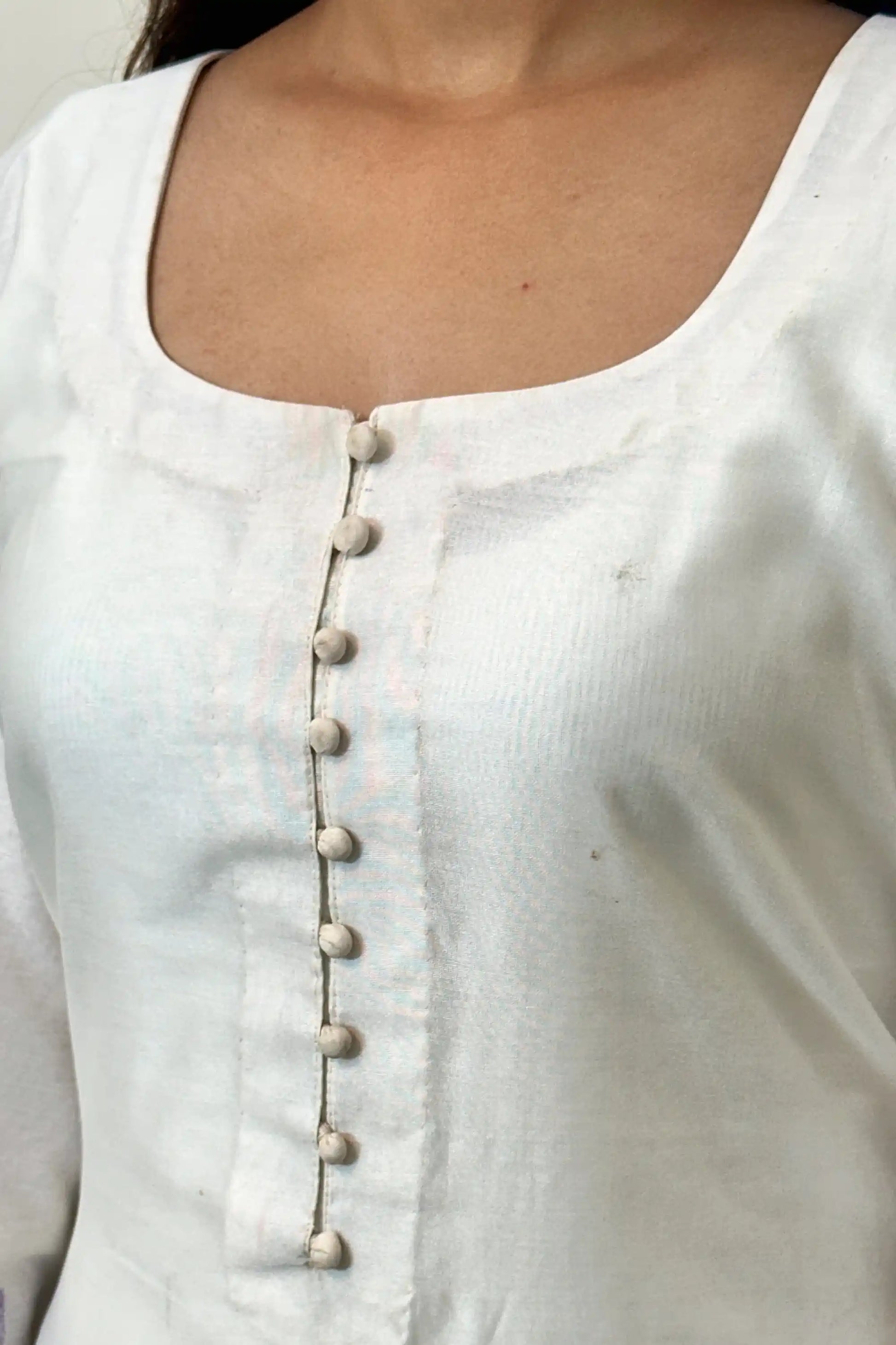 Close-up of the button placket on the off-white chanderi straight kurta.
