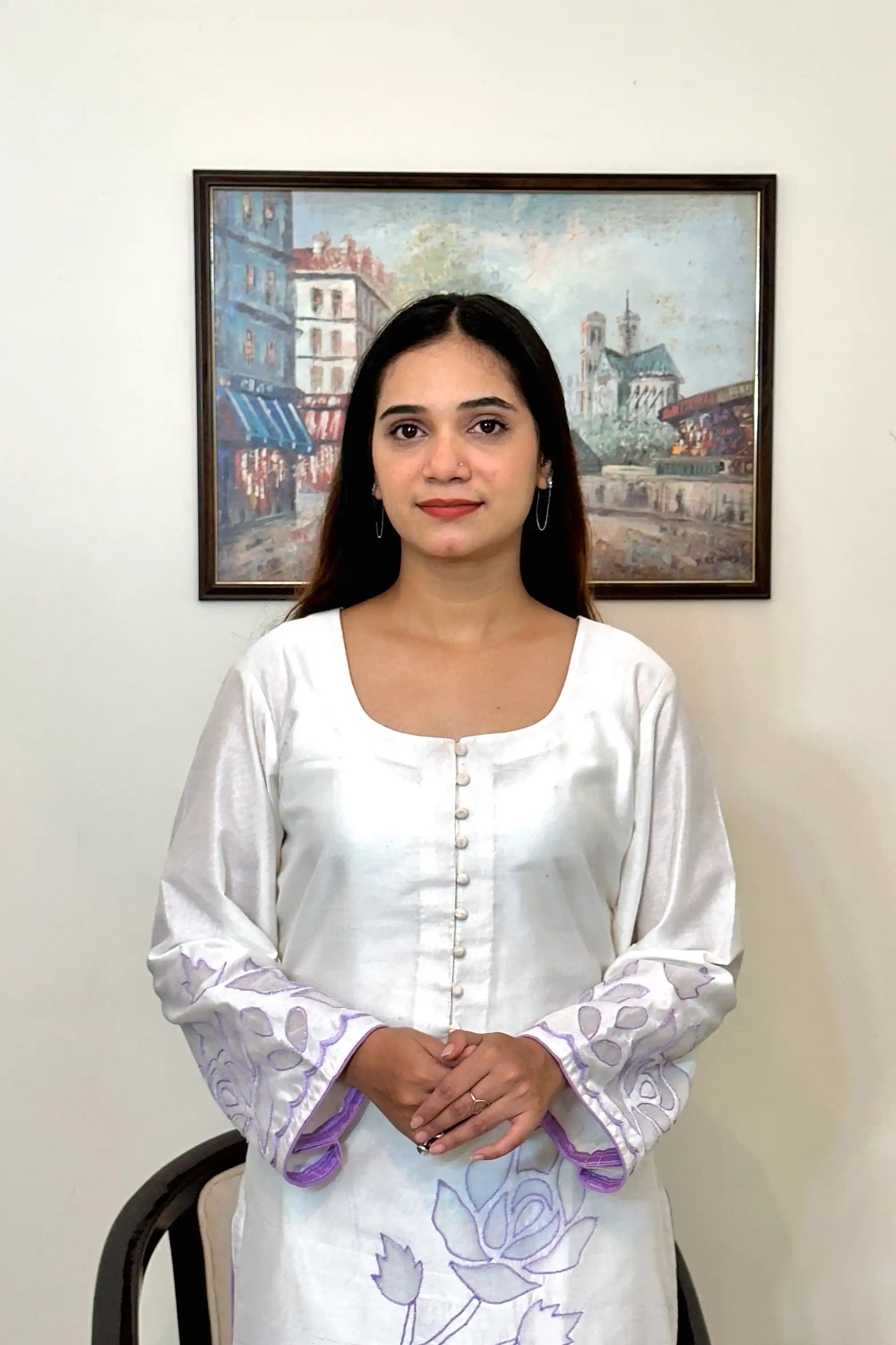 Front close-up of the off-white chanderi straight kurta showing the button placket and floral cutwork embroidery on the sleeve.