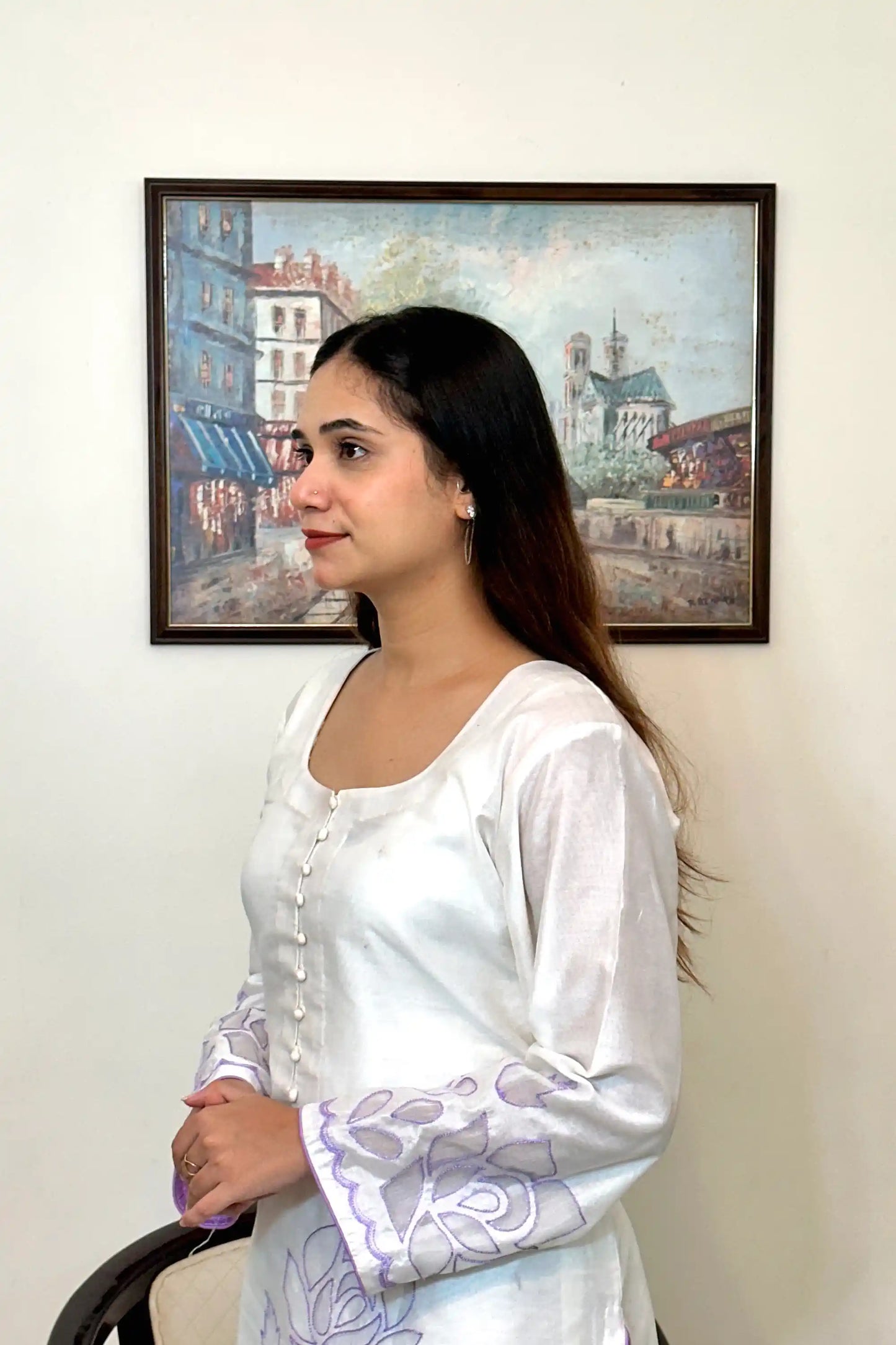 Side close-up of the off-white chanderi straight kurta showing the button placket and floral cutwork embroidery on the sleeve.