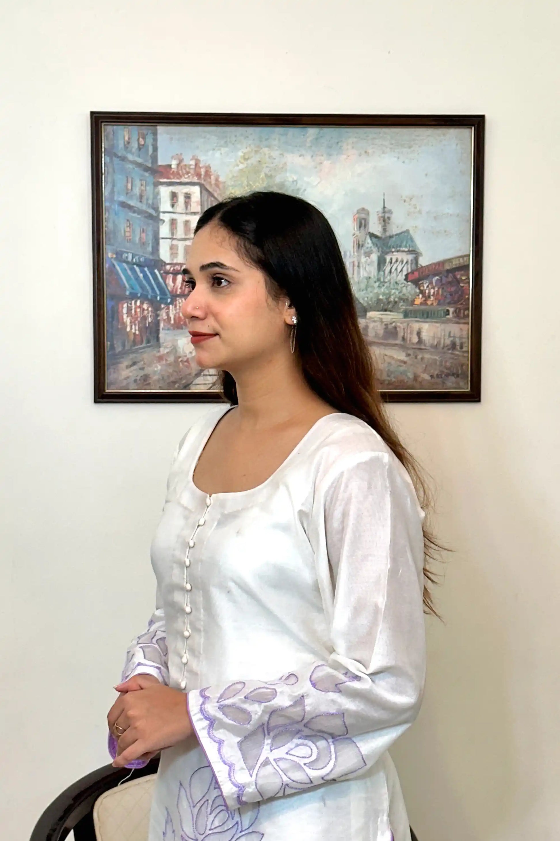 Side close-up of the off-white chanderi straight kurta showing the button placket and floral cutwork embroidery on the sleeve.