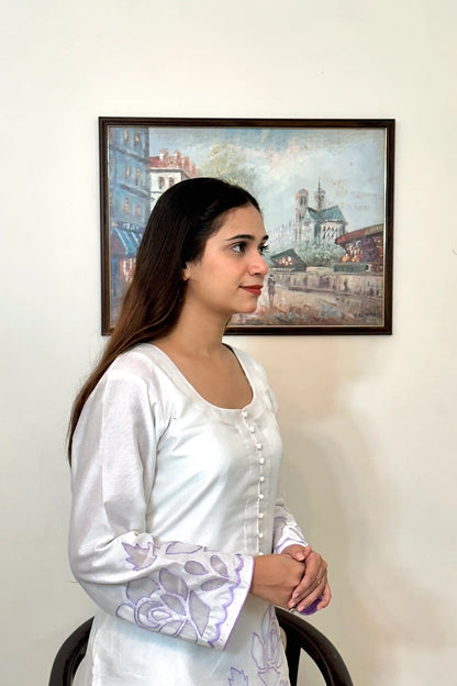 Side close-up of the off-white chanderi straight kurta showing the button placket and floral cutwork embroidery on the sleeve.