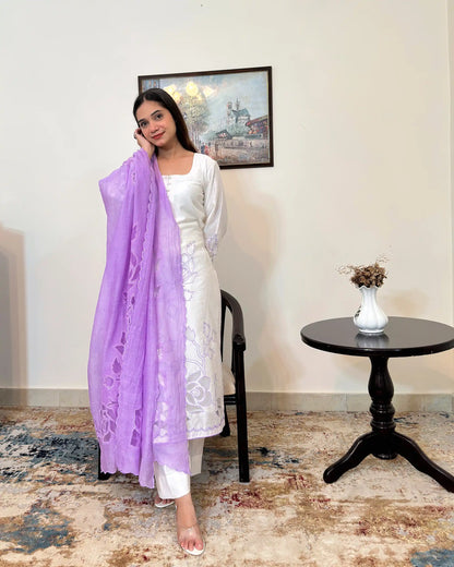 Front view of the off-white chanderi straight kurta with floral cutwork embroidery, paired with the purple chanderi dupatta with floral cutwork and off-white trousers, dupatta on.