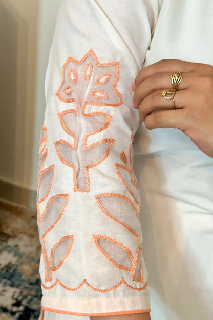Close-up of the sleeve of the off-white chanderi kurta showing floral cutwork detailing.