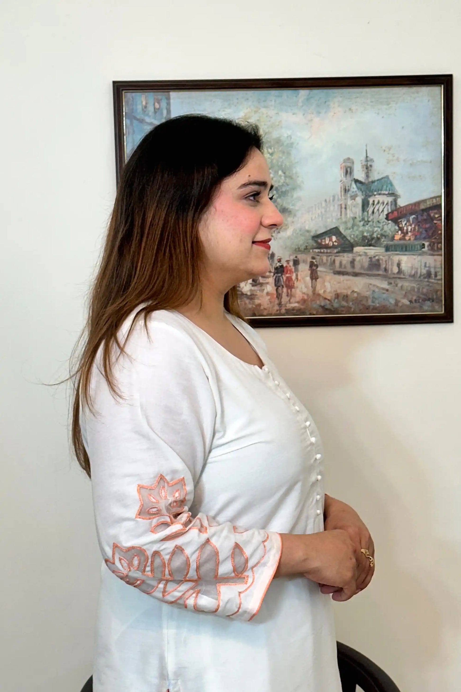 Side view close-up of the off-white chanderi kurta showing the button placket and floral cutwork on the sleeve.