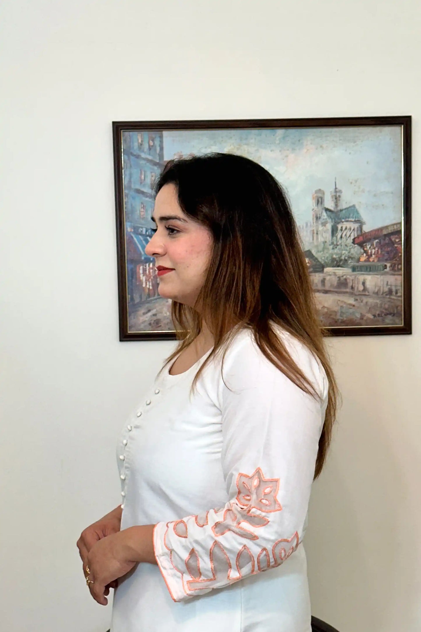 Side view close-up of the off-white chanderi kurta showing the button placket and floral cutwork on the sleeve.