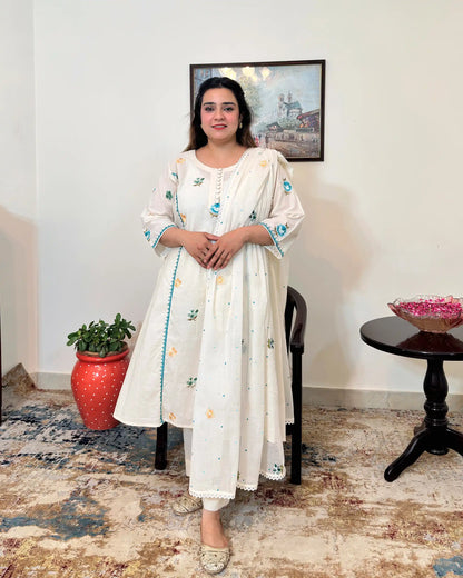 Front view of an off-white cotton frock kurta and dupatta with multicolour floral resham embroidery, worn with off-white trousers.
