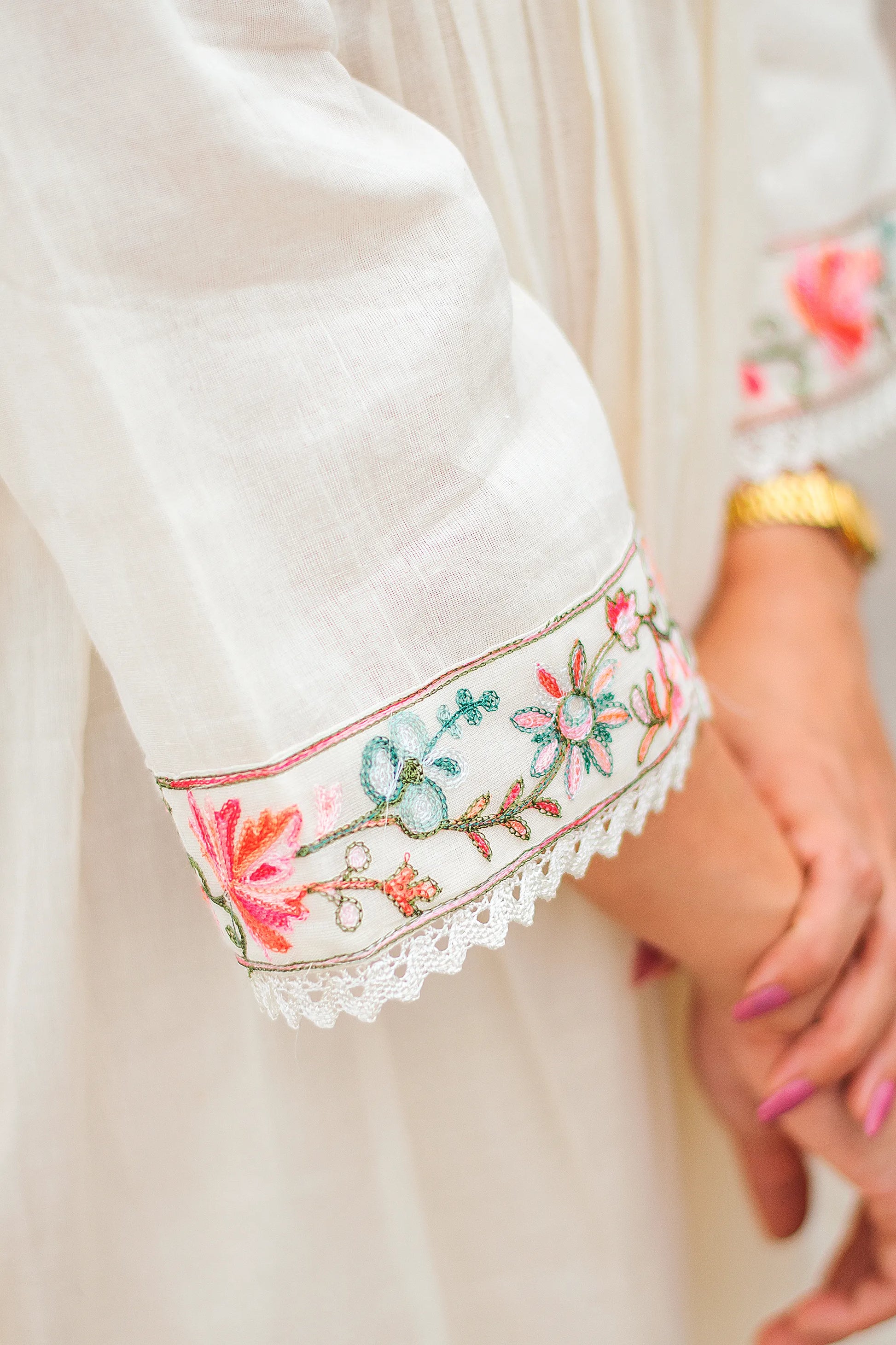 Close-up of Kashmiri embroidery on the sleeve of an off-white cotton Anarkali kurta.