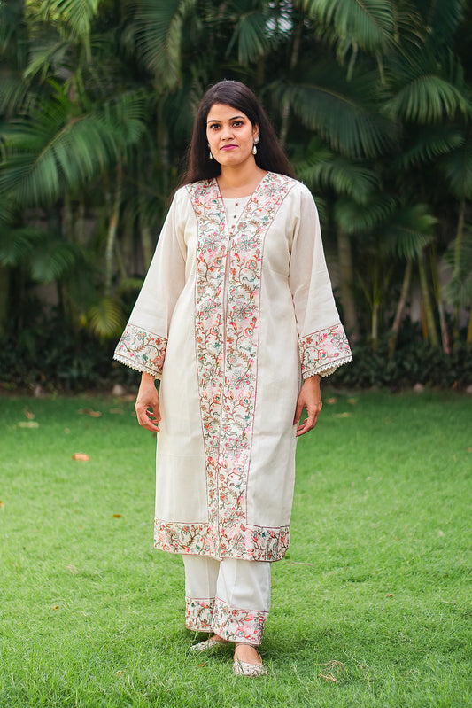 Indian model in an off-white cotton kurta and trousers with Kashmiri embroidery,