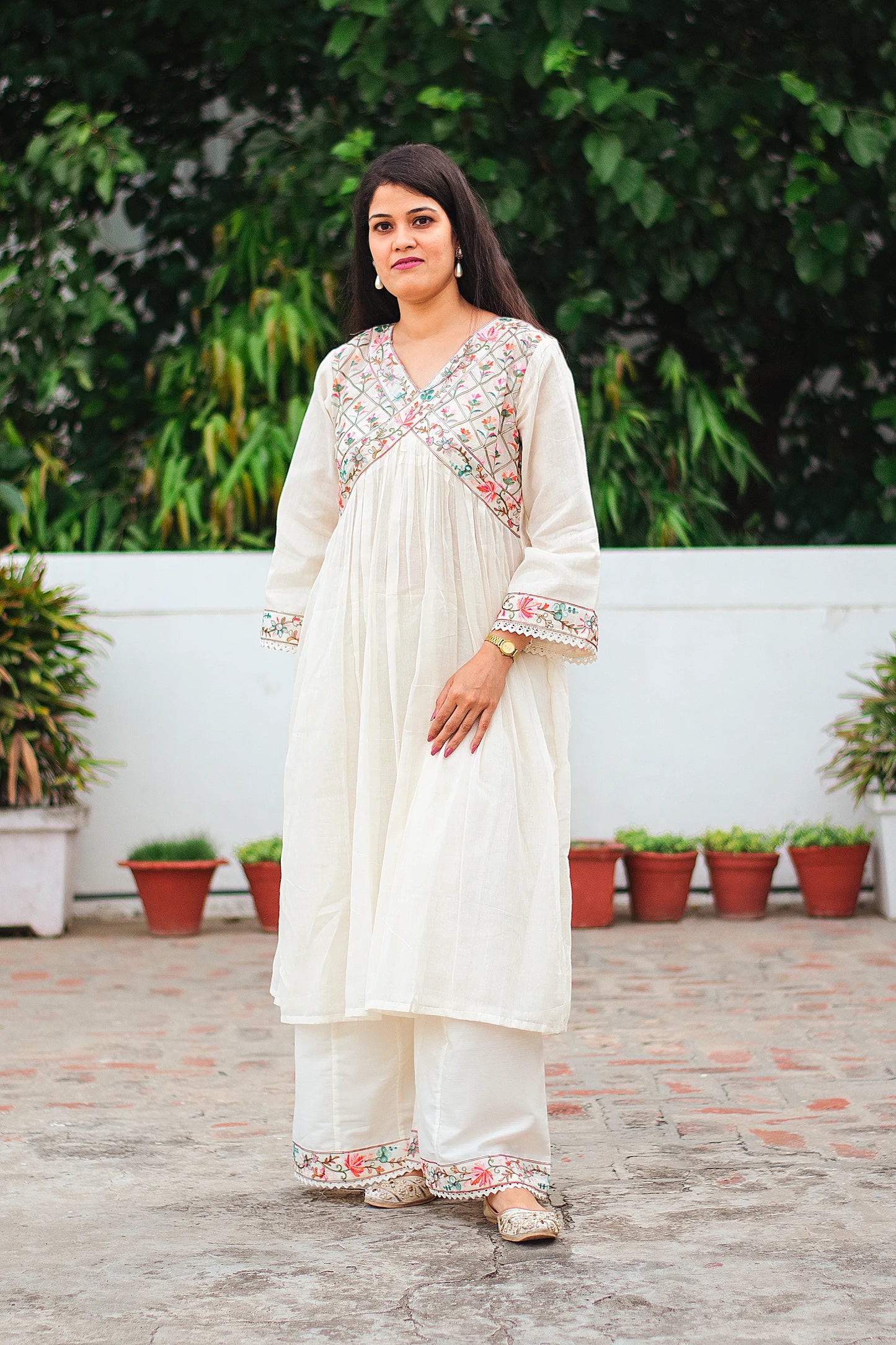 Indian model wearing an off-white Anarkali kurta with Kashmiri embroidery and an off-white palazzo, 