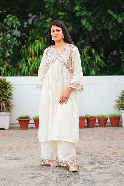 Indian model wearing an off-white Anarkali kurta with Kashmiri embroidery and an off-white palazzo, 