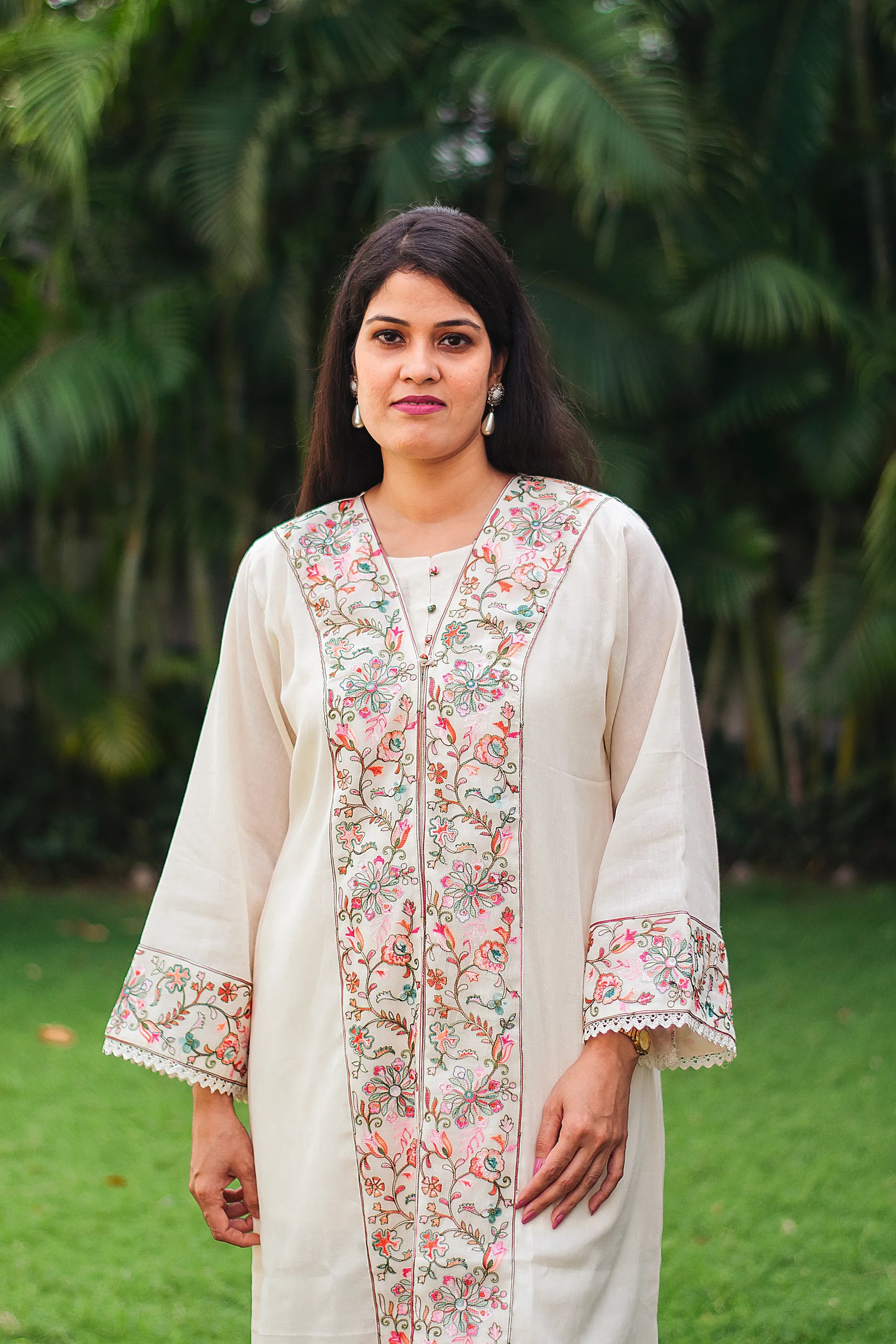 Close-up of Indian model showing the off-white cotton kurta with Kashmiri embroidery