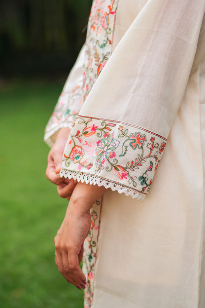 Close-up of Kashmiri embroidery on the sleeve of an off-white cotton kurta.