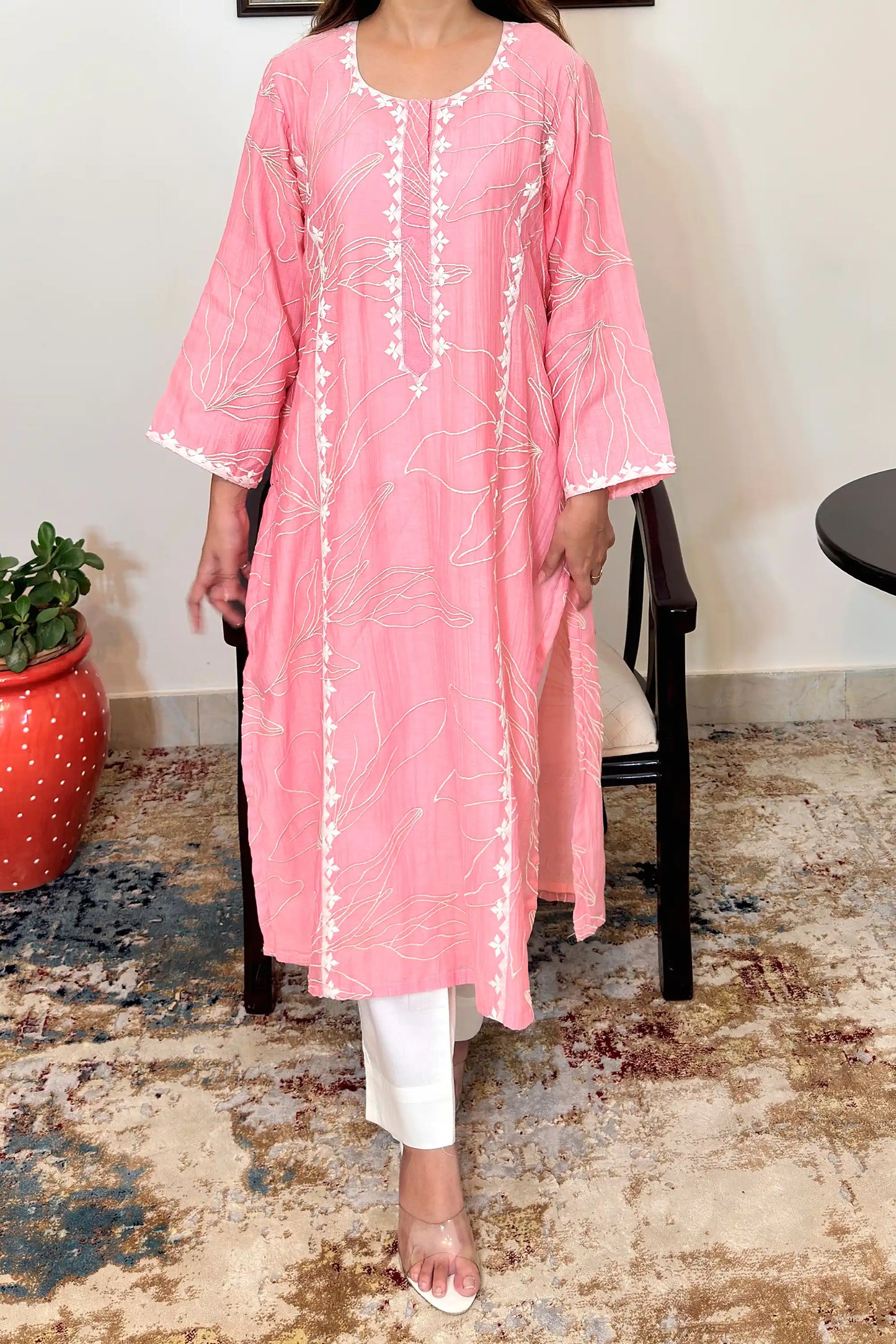 Front view of the pink chanderi kalidar kurta's upper body, showing floral resham embroidery across the bodice and off-white applique work along the neckline and button placket.