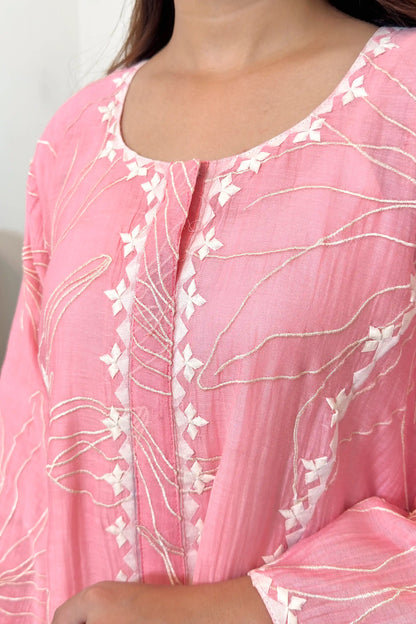 Close-up of the neckline and button placket, showing off-white applique diamond motifs along the placket and resham embroidery on the surrounding fabric.