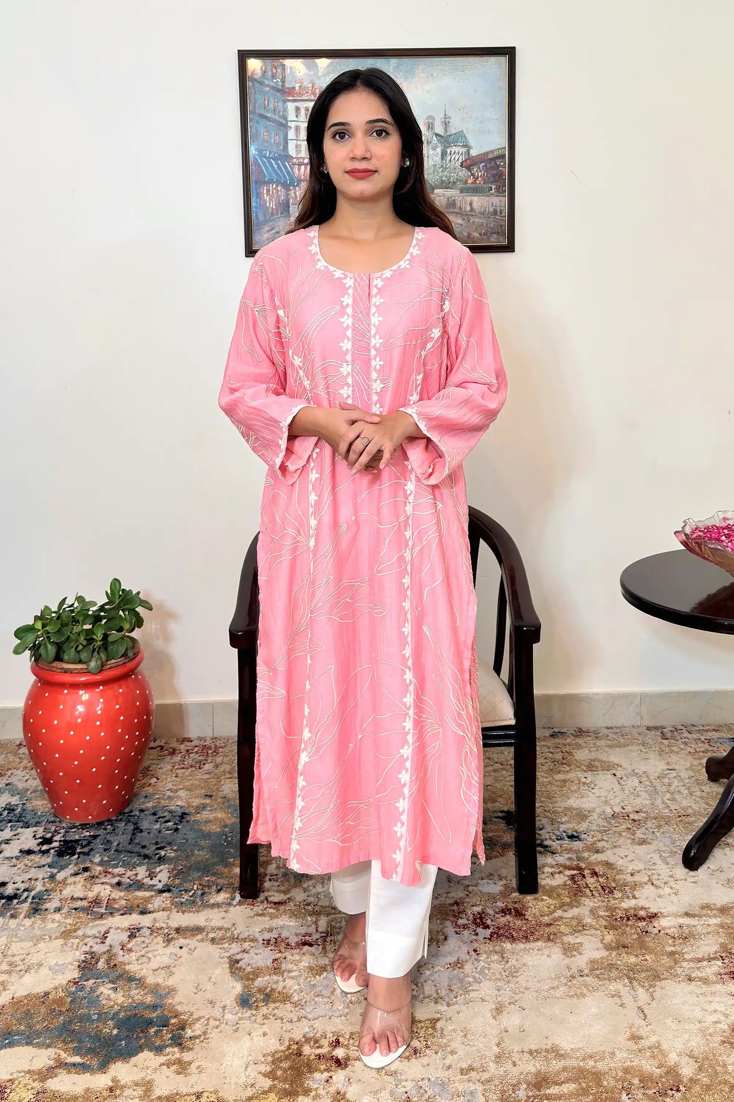 Front view of the pink chanderi kalidar kurta and off-white cotton-silk trousers, showing floral resham embroidery across the bodice and the side slits.
