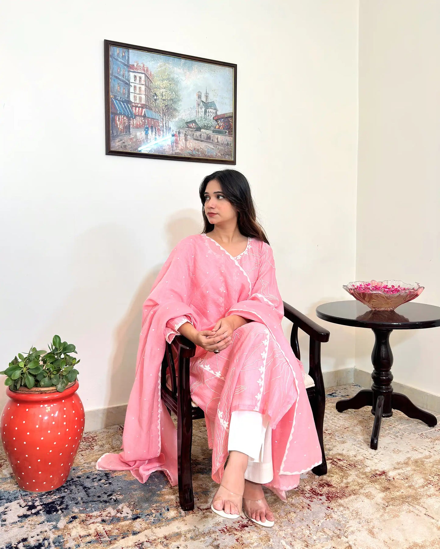 Model seated in a chair wearing the pink chanderi kalidar kurta with the dupatta draped over the shoulder, looking to the side.