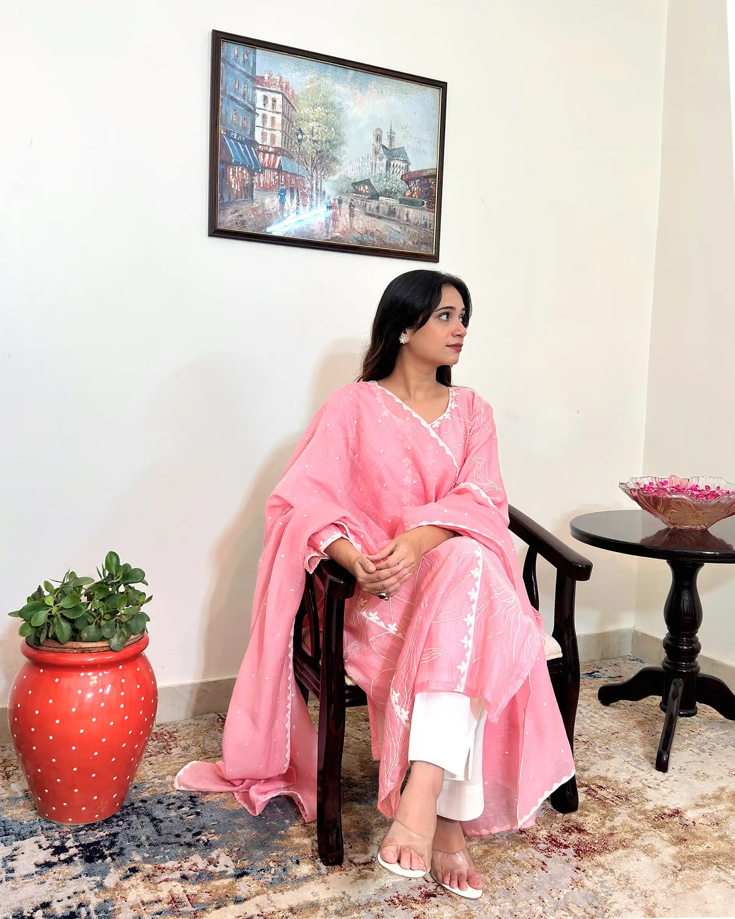 Model seated in a chair, shown at a three-quarter angle, wearing the pink chanderi kalidar kurta with the dupatta draped over the shoulder.