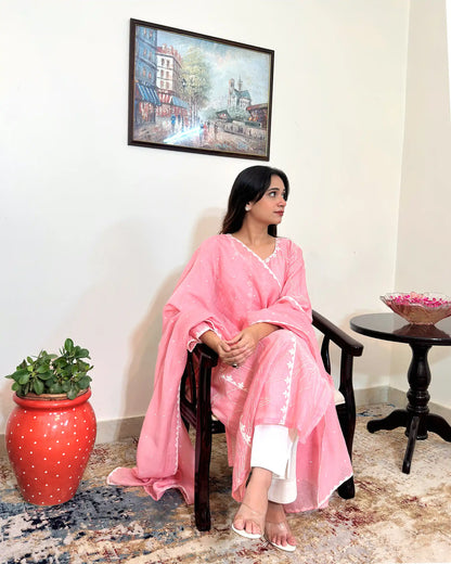 Model seated in a chair, shown at a three-quarter angle, wearing the pink chanderi kalidar kurta with the dupatta draped over the shoulder.