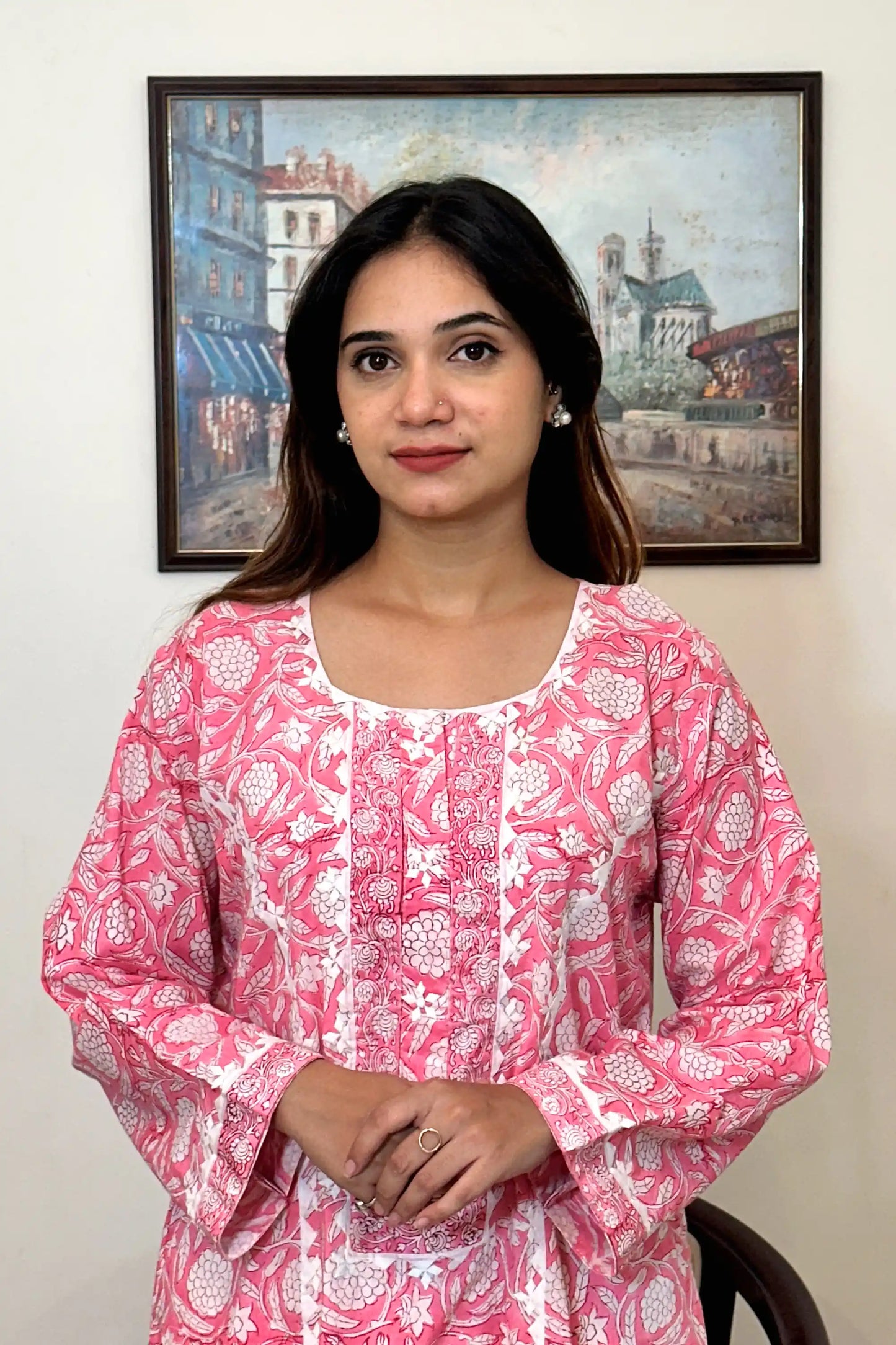 Front view of the pink floral block-printed mulmul cotton kurta's upper half, showing the off-white appliqué yoke and appliqué work along the front kalis.