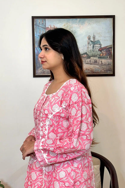 Left side view of the model showing the pink floral block-printed mulmul cotton kurta's upper half, with the sleeve and cuff visible.