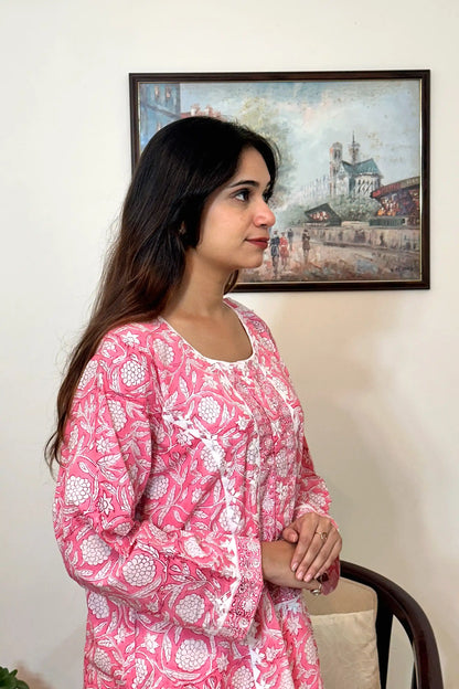 Right side view of the model showing the pink floral block-printed mulmul cotton kurta's upper half, with the sleeve cuff visible.