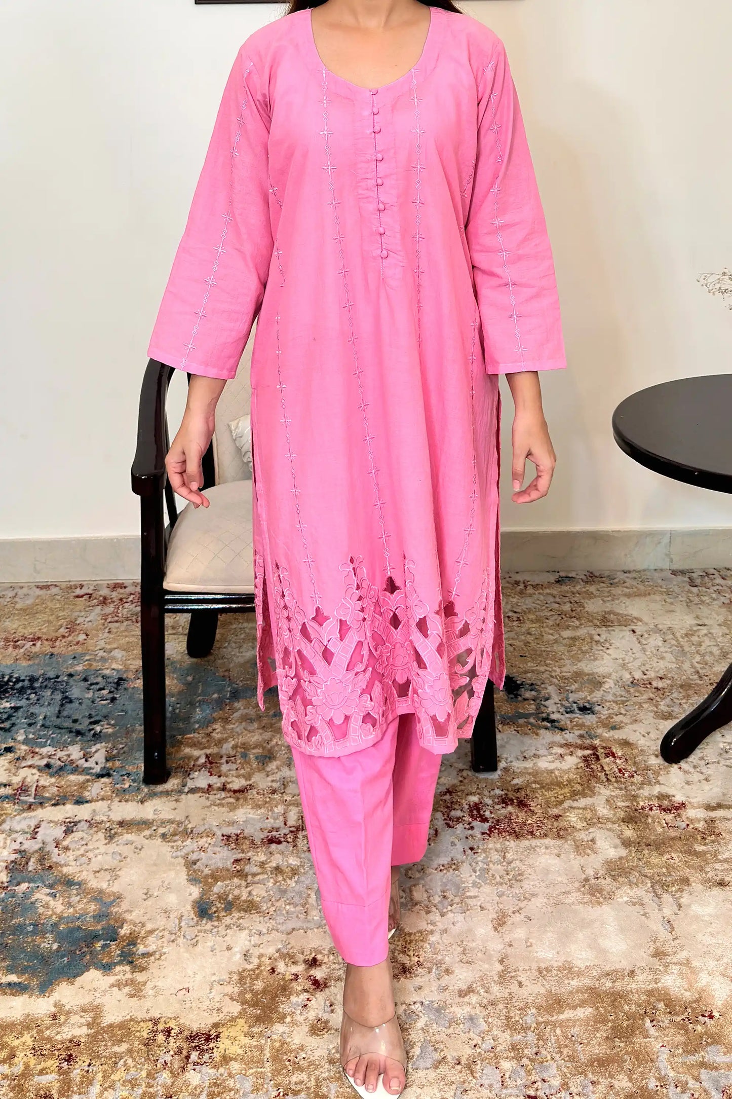 Front view of the pink cotton straight kurta's upper body, showing the button placket and the embroidered diamond and star motifs down the front panels.