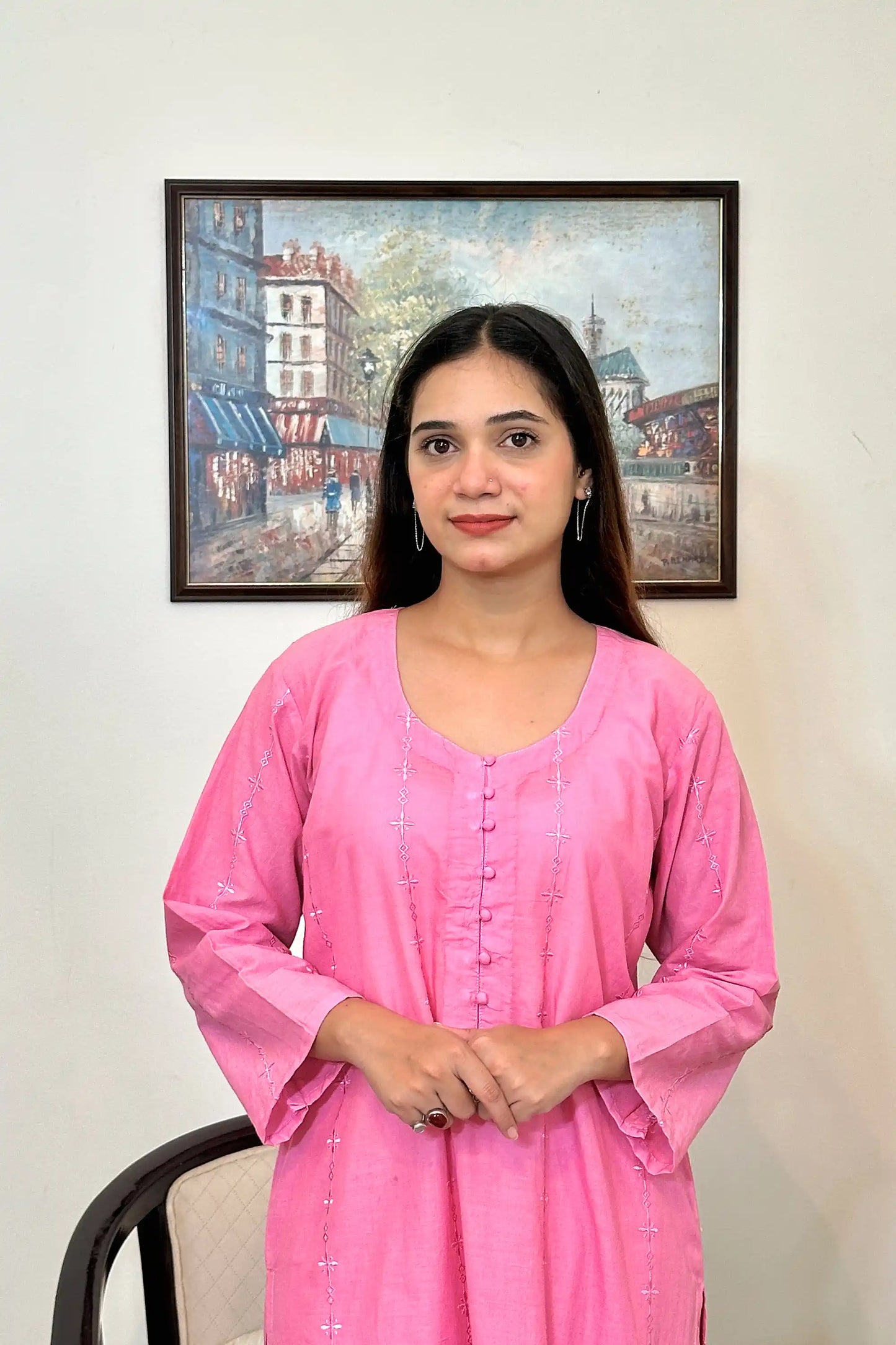 Front view of the pink cotton straight kurta's upper half, showing the button placket and embroidered diamond and star motifs.