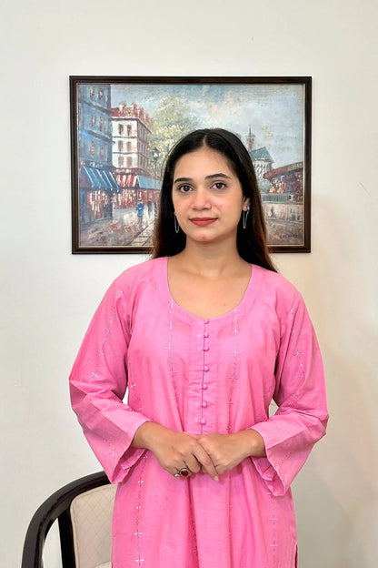 Front view of the pink cotton straight kurta's upper half, showing the button placket and embroidered diamond and star motifs.