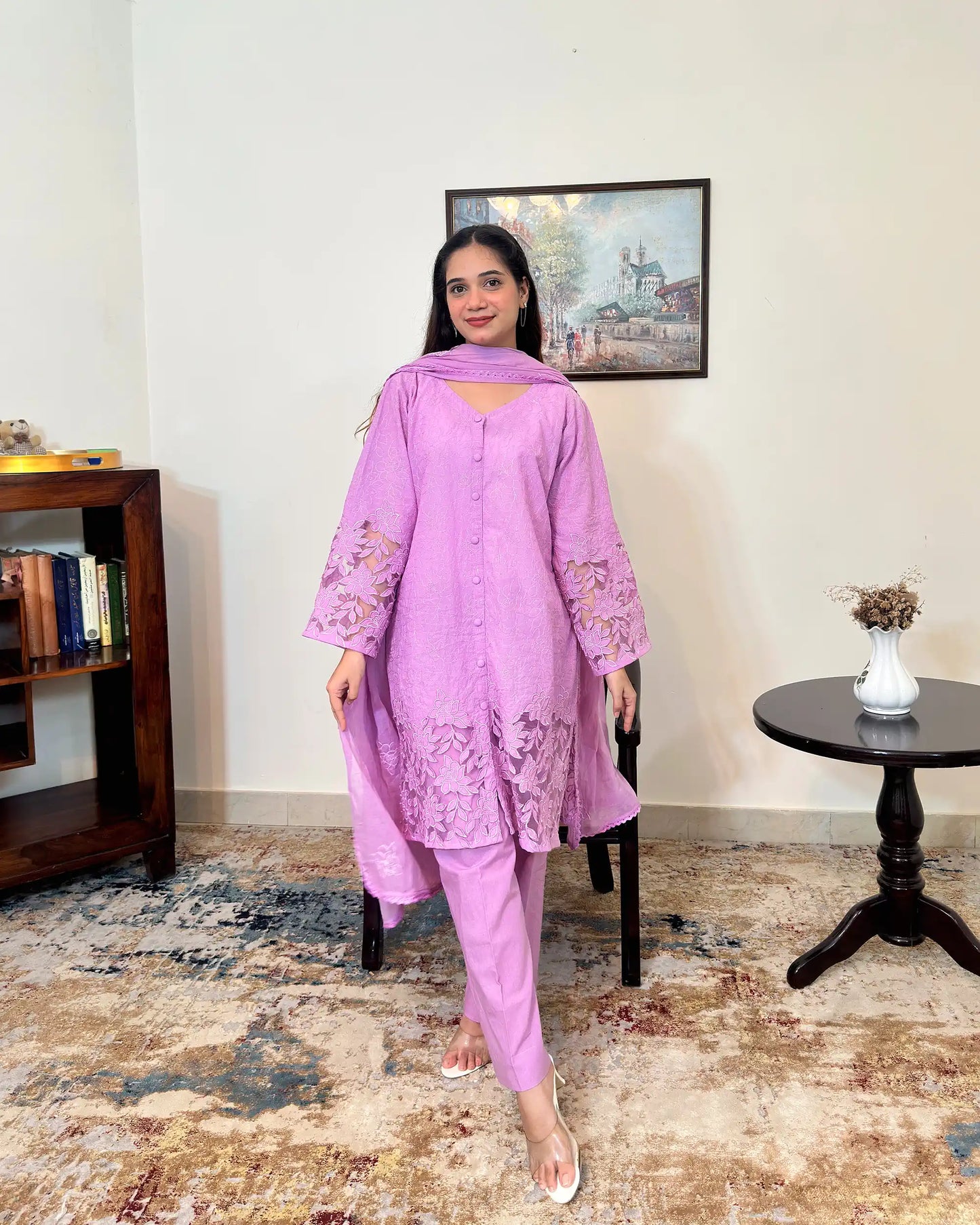 Front view of a purple cotton straight kurta with dupatta, worn with purple trousers, featuring floral cutwork embroidery at the sleeves and hem.