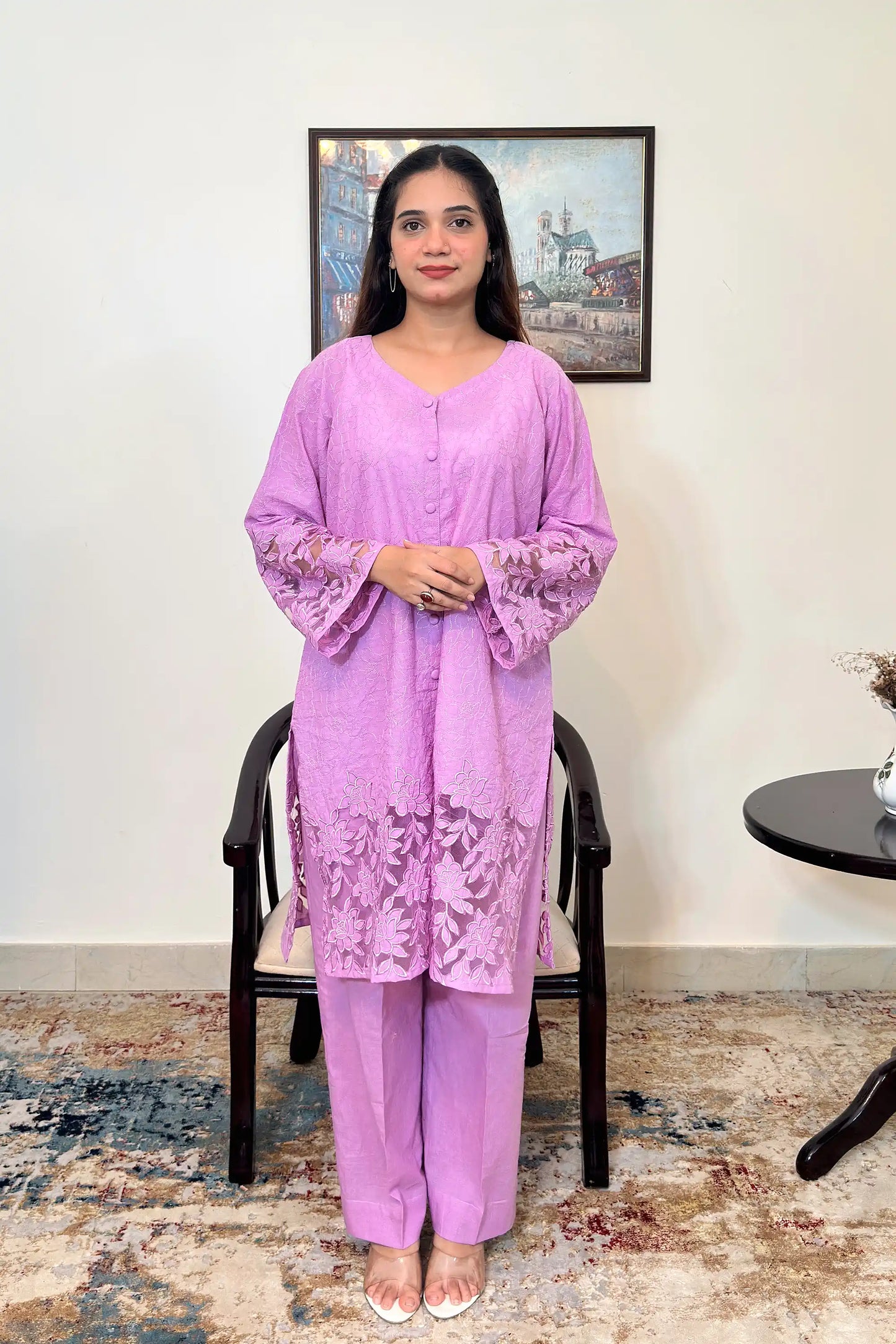 Front view of a purple cotton straight kurta, worn with purple trousers, featuring floral cutwork embroidery at the sleeves and hem.